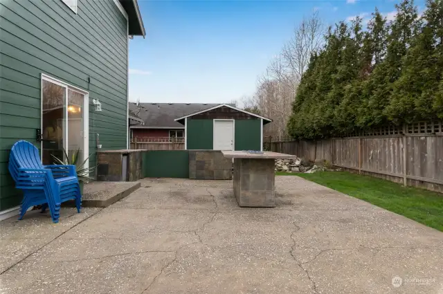 Large patio with outdoor kitchen.  Table has propane gas fireplace in the middle