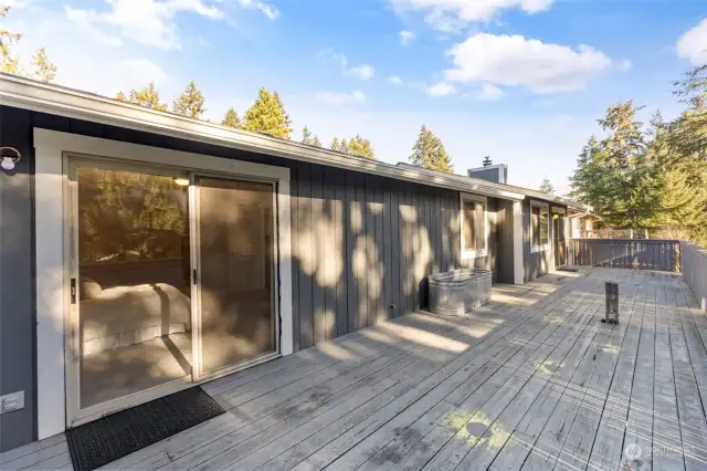 Main floor balcony with sliding glass doors from living room and primary bedroom