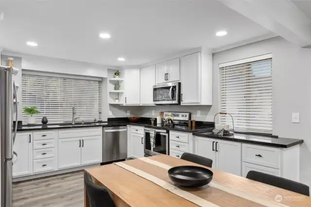 Updated kitchen with new appliances and black granite countertops