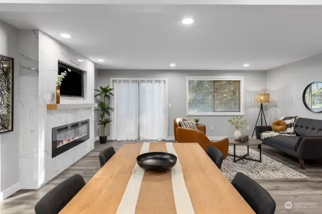 Bright living room with cutom tile fireplace and slider onto balcony