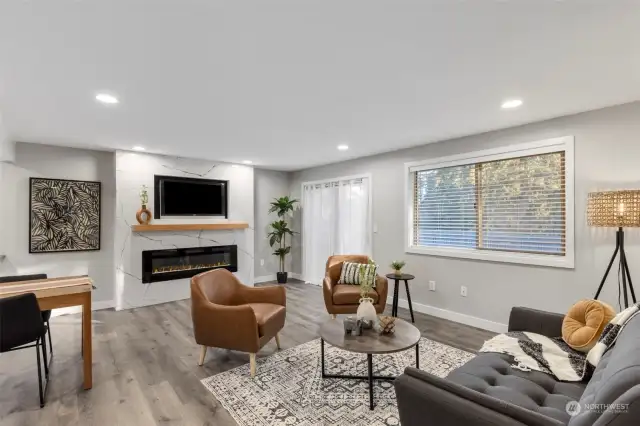 Bright living room with cutom tile fireplace and slider onto balcony