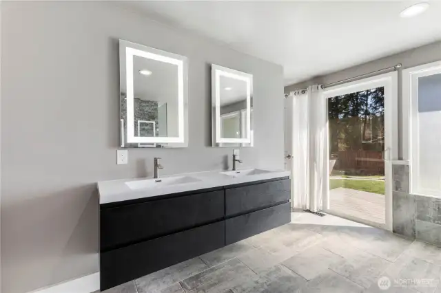 Main level primary bathroom with access to back deck and pool.
