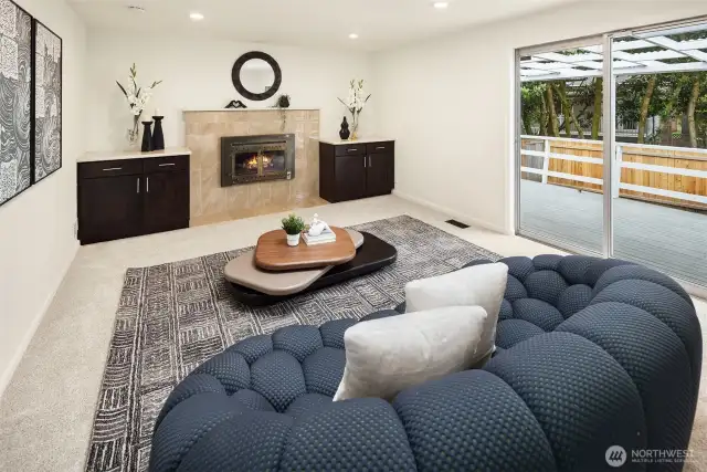 The inviting family room centers around a gas fireplace flanked by elegant custom built-ins. Step outside to your backyard oasis—complete with a large wraparound deck and a charming brick patio—perfect for alfresco dining or relaxing under the stars.