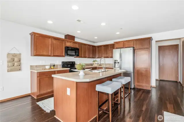 Open design kitchen with center island and wide plank floors