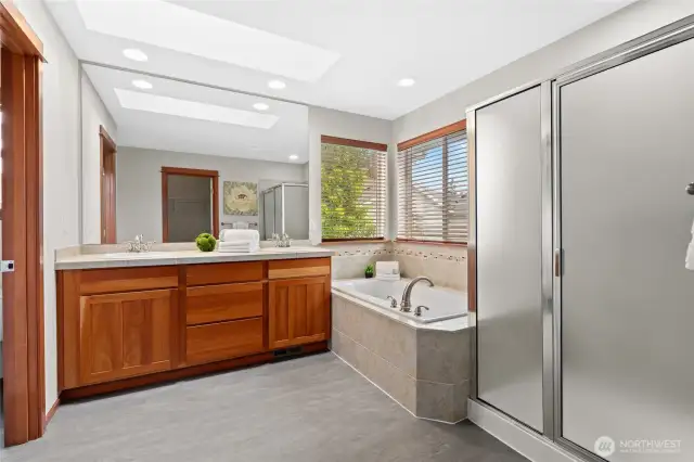 Lovely Primary Bath with rich wood cabinetry, dual sinks & large soaking tub. New flooring!