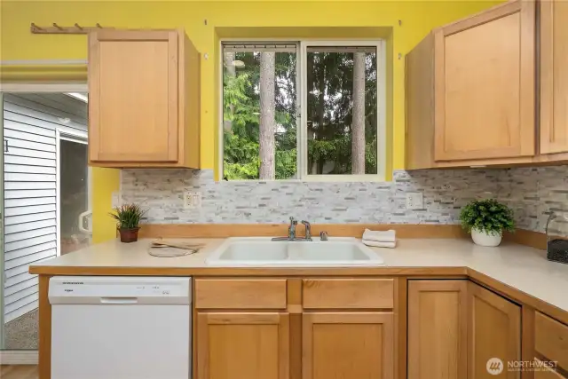 Kitchen sink offers a view of the greenbelt behind the home.