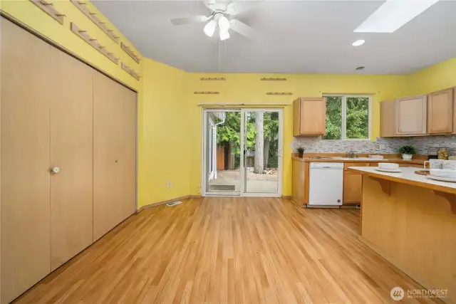 Eat-in area in the kitchen offers slider to backyard and the bi-fold doors on the left open to a large pantry.