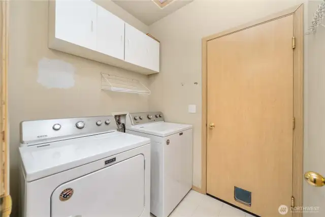 Utility room is located in the pass-thru to the garage.