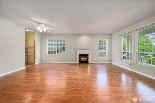 As you enter, this large living - dining area offers a gas fireplace and lots of windows to keep it bright. The covered front porch is on the right of this photo.