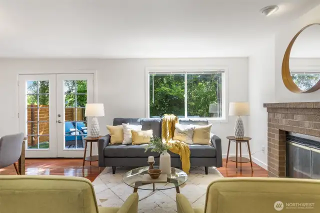 Wonderful great room with wood-burning fireplace, French doors, smart layout, and dining room area!