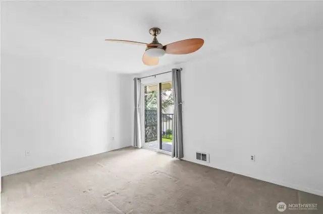 Spacious primary bedroom has a balcony too!