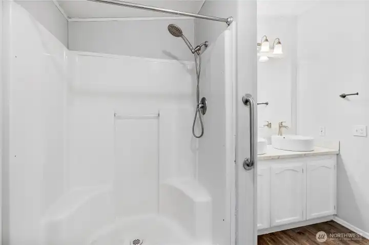Primary bathroom walk in shower and large linen closet.