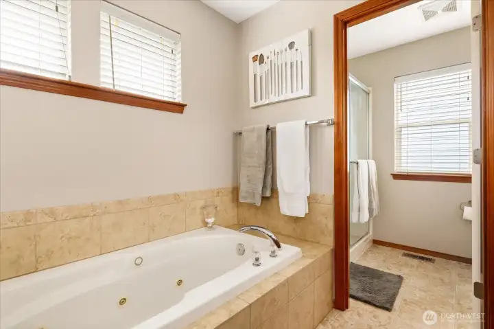 Large jetted tub awaits, with private shower and toilet behind.