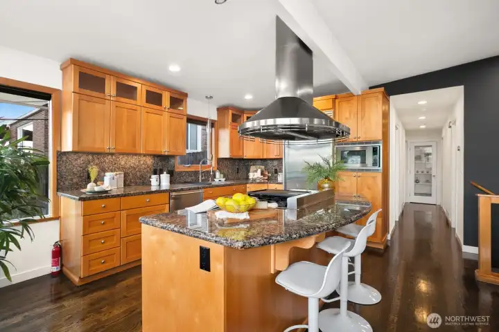 Across from the living room, the dining area and modernized kitchen with bar...