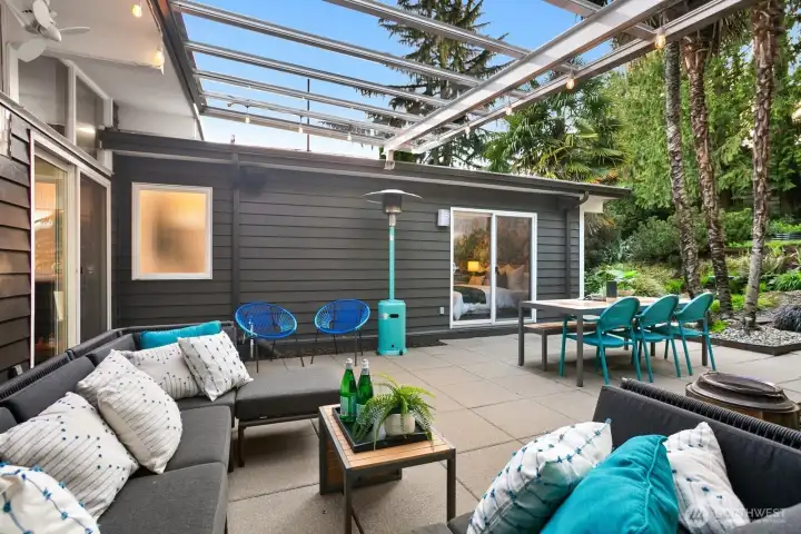 Thanks to the glass awning, this is a true "outdoor room" usable in all seasons and weather, and two groves of palm trees lend a vacation vibe.