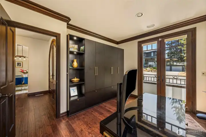 Den/Office - Possible bedroom: Versatile main-floor bedroom or den with rich wood trim and abundant natural light — ideal for guests or home office.