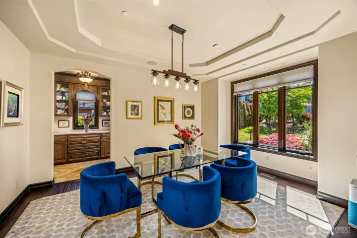 Main Floor Dining Room: Sophisticated dining room with designer lighting and views to the outdoors, perfect for elegant entertaining.