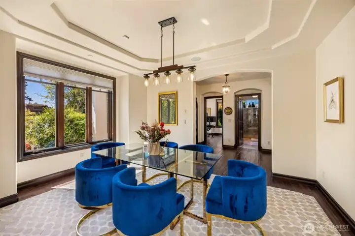 Main Floor Dining Room: Open-concept dining space flowing seamlessly to the living areas, framed by graceful archways.
