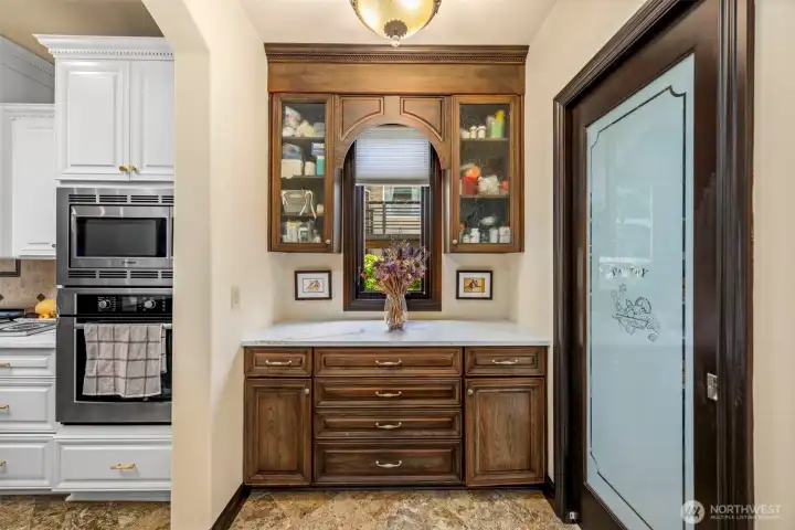 Butler's Pantry: Refined butler's pantry with custom cabinetry, connecting kitchen to dining room.