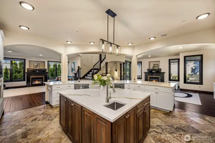 Main Floor Kitchen: Chef's kitchen with expansive quartz island, designer pendants, and seamless flow to the family room.