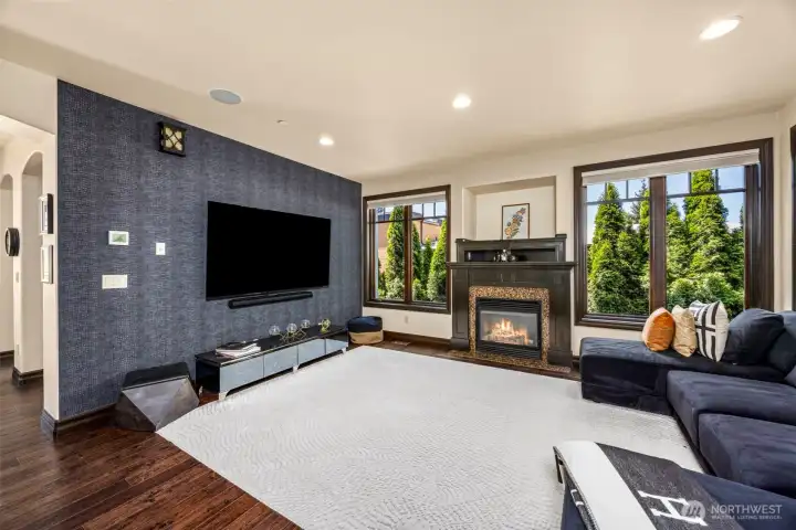 Main floor family room open to the kitchen: Inviting family room with cozy fireplace, opening seamlessly to the kitchen for effortless flow.