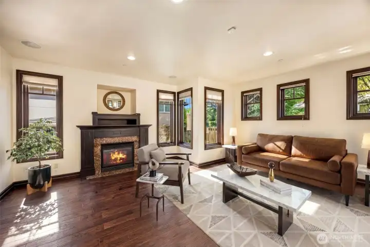 Main Floor Living Room: Expansive living room with cozy fireplace and rich flooring — a welcoming gathering space.