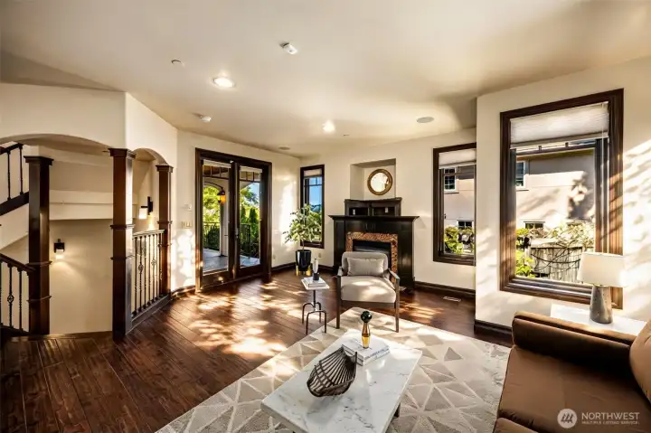 Main Floor Living Room: Open living area with fireplace and graceful archways leading to the main hallway.
