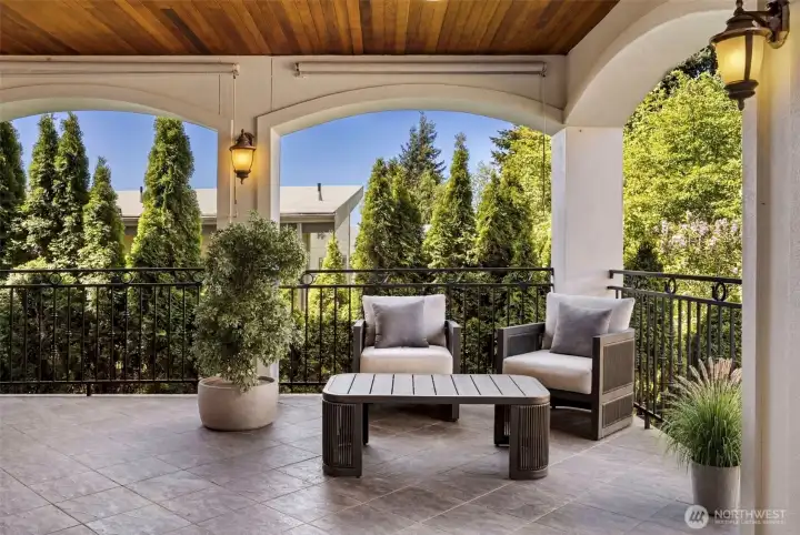 Main Floor Balcony: Charming covered outdoor balcony with wood-paneled ceiling — seamless indoor-outdoor living for entertaining.