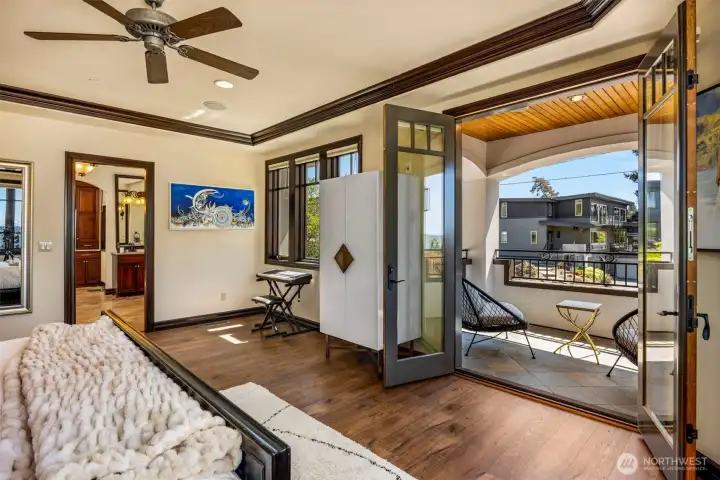 Upper level Primary bedroom with sitting patio area: Primary Suite featuring an adjoining seamless flow to the private balcony — a true sanctuary.