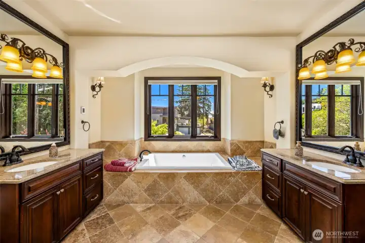 Primary bathroom dual sinks: Elegant Primary bath with dual vanities, designer lighting, and arched architectural detailing. Heated floors.