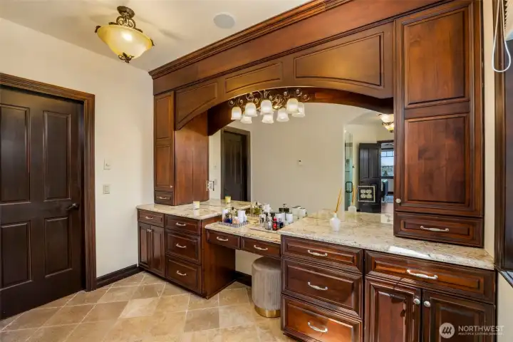 Primary bedroom Vanity: Custom built-in vanity with rich wood cabinetry — a refined dressing area within the Primary Suite. Heated floors.