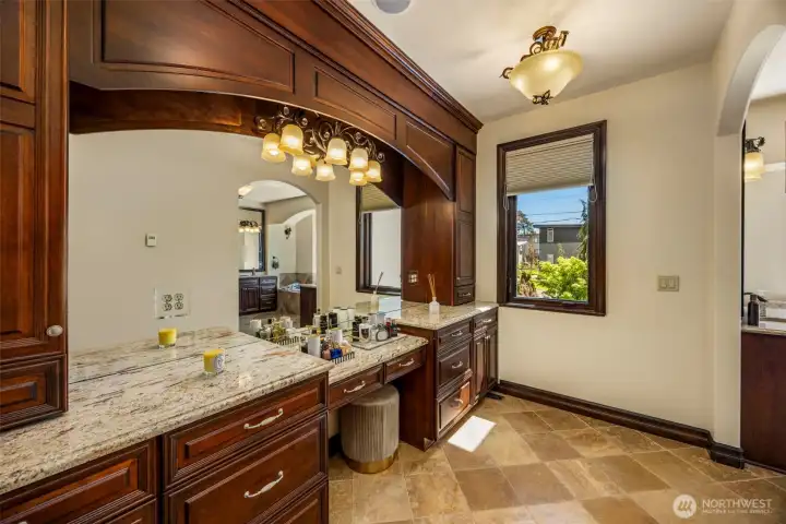 Primary bedroom Vanity: Expansive Primary vanity, designer lighting, and ample storage. Heated floors.