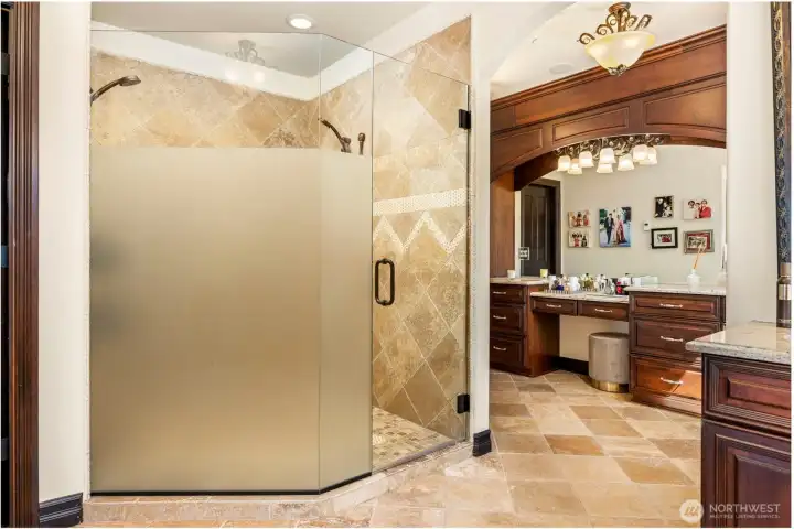Primary bedroom walk-in shower: Luxurious walk-in shower with floor-to-ceiling tile and frameless glass enclosure. Heated floors.