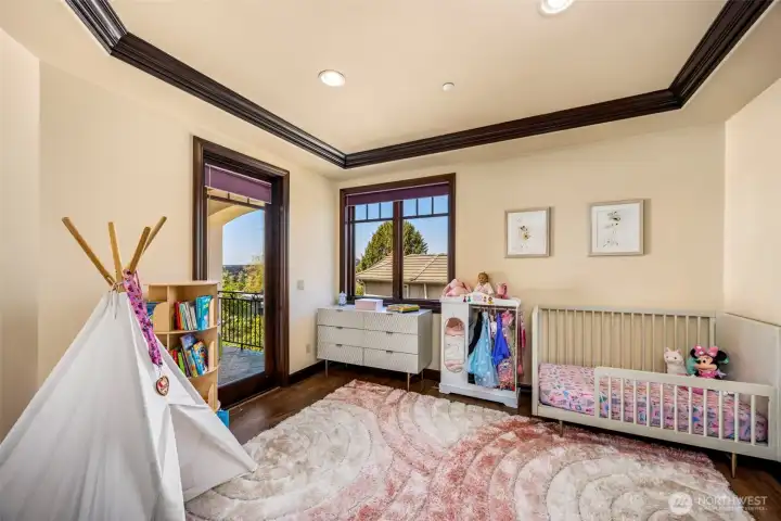 Upper level bedroom 3: Bright upper-level bedroom with private balcony access, elegant ceiling detail, and large windows offering abundant natural light.