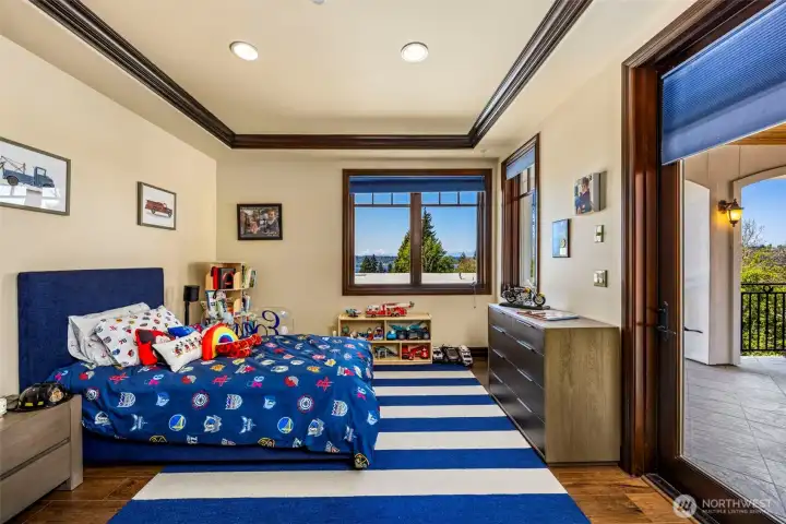 Upper level bedroom 2 with balcony access: Upper-level bedroom with private balcony access and territorial views — every bedroom on this floor enjoys its own outdoor space.