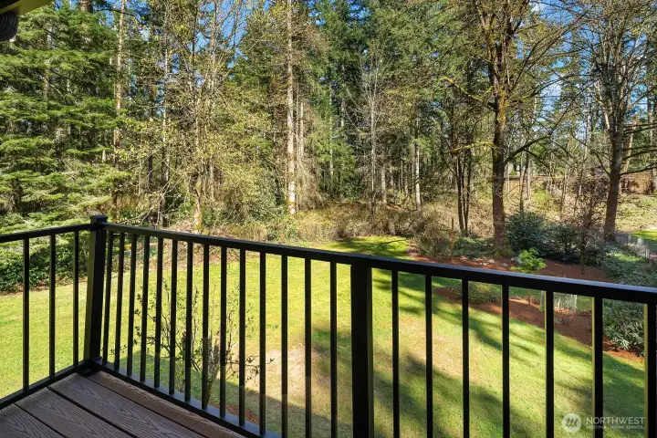 The primary suite's exclusive private deck offers breathtaking, tree-framed views of the lush, beautifully landscaped backyard — a rare and peaceful sanctuary perfect for enjoying your morning coffee or an evening sunset in complete privacy. This exceptional outdoor space elevates the primary suite into a true personal retreat.