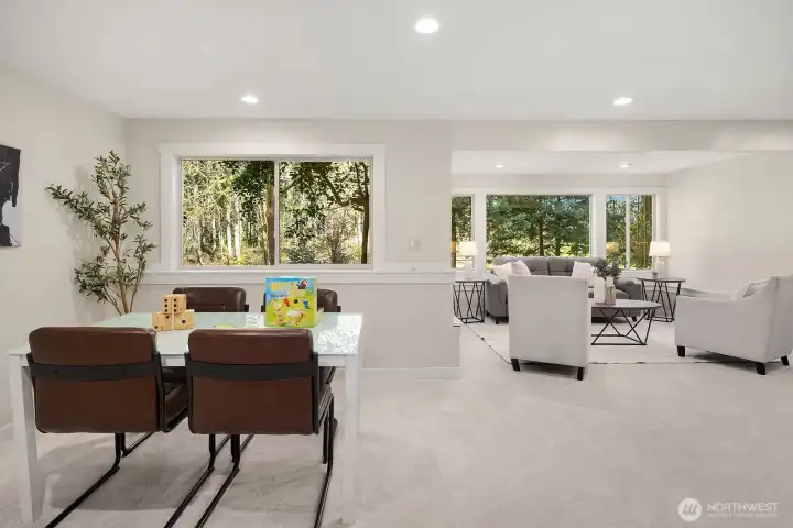 The spacious lower level living area offers incredible flexibility as a fully functional ADU, featuring plush new carpet, fresh paint, and large windows that fill the space with surprising natural light. This generous open layout effortlessly accommodates a separate living and dining area, making it a truly self-contained and comfortable retreat for guests or extended family.