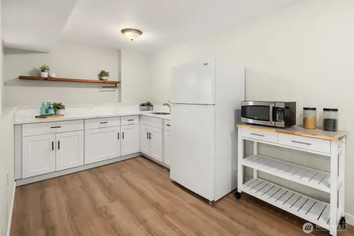 The lower level ADU features a fully functional kitchenette complete with a refrigerator, sink, and ample cabinetry, providing everything needed for independent, comfortable living without sharing the main level kitchen. This thoughtfully designed space adds tremendous value and flexibility, whether used for extended family, guests, or potential rental income.