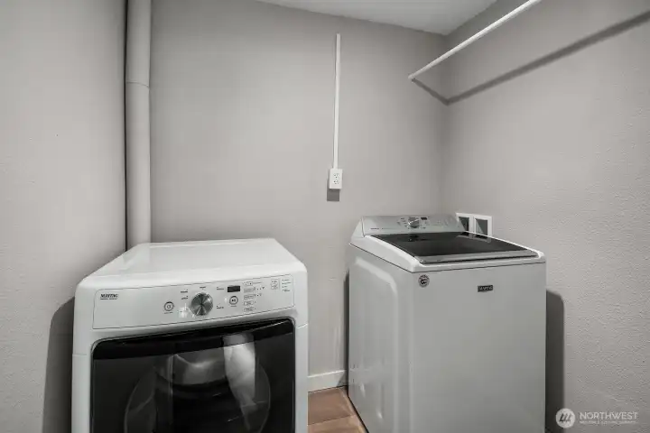 A second dedicated laundry room on the lower level features a full-size washer and dryer, ensuring complete independence and convenience for the ADU's occupants. This practical addition eliminates the need to share laundry facilities with the main level, making the lower level a truly self-sufficient living space.