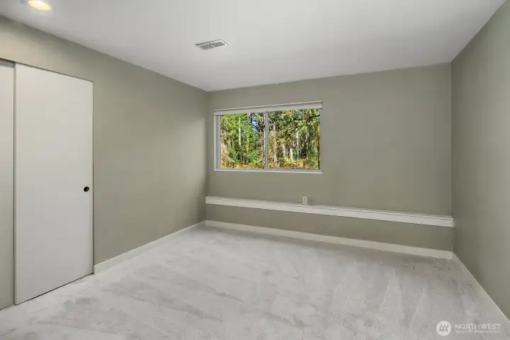 This second lower level bedroom offers a clean, bright, and versatile space with new carpet, fresh neutral paint, and a large window providing natural light and garden views. Generously sized and move-in ready, this room completes the ADU's fully functional two-bedroom layout, ideal for guests, family members, or a quiet home office.