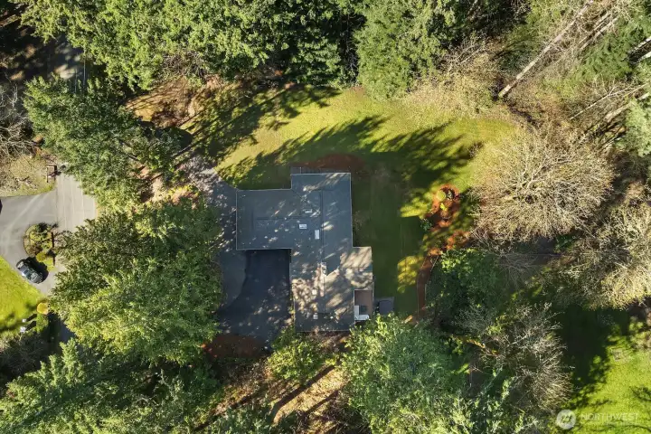 An aerial view reveals the home's charming raised garden planter boxes, perfectly positioned and ready for a green thumb to bring to life — a true gardener's dream come true. Nestled within the beautifully landscaped grounds, these thoughtfully installed planters are just one more detail that makes this exceptional Sammamish property truly special.