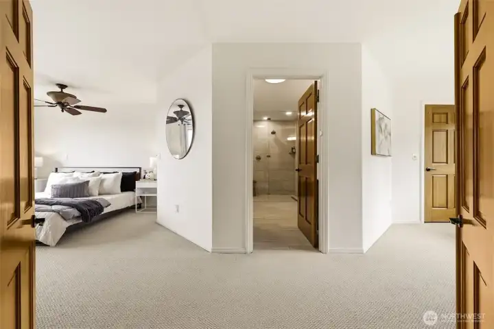 A look into the primary suite with the spa-like ensuite beyond.