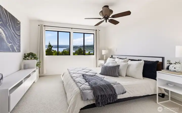 Upstairs, the spacious primary bedroom feels bright, open, and serene.