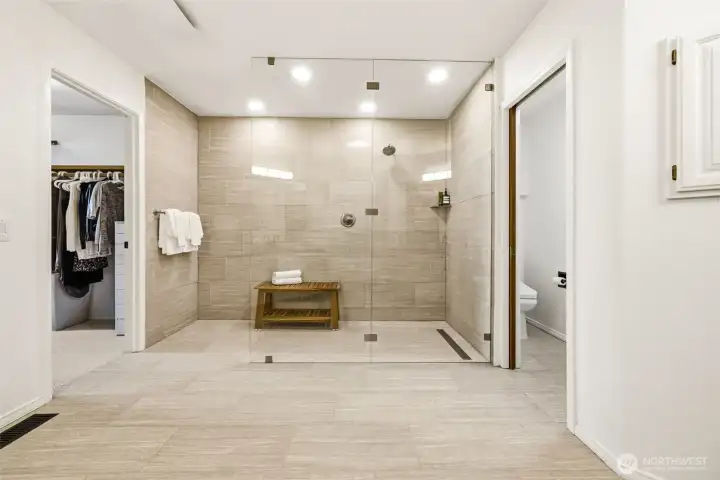 The primary bath has been refreshed with updated finishes and a spacious shower.