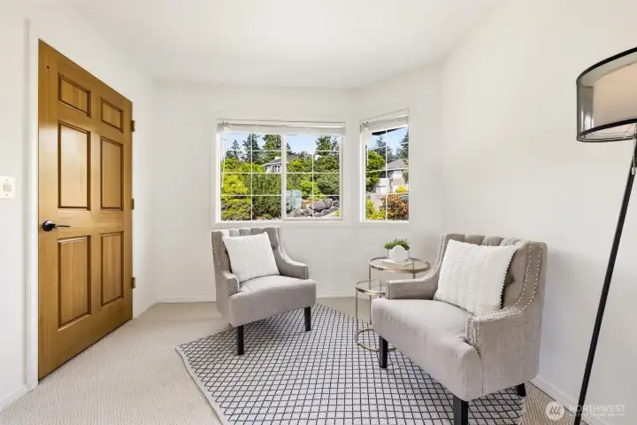 A private sitting area in the primary suite, with the elevator door nearby.