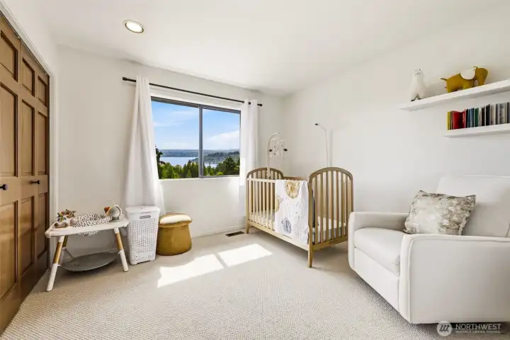 A bright second-floor bedroom with beautiful lake views.