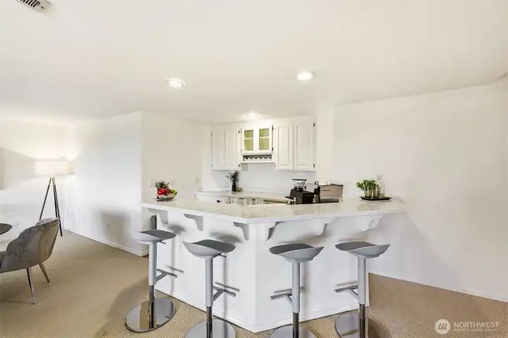 Bar seating, cabinets, and storage add function to the lower level.