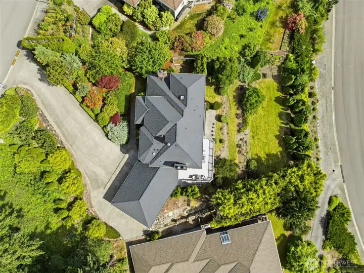 Aerial perspective highlights the home’s private setting and mature landscape.
