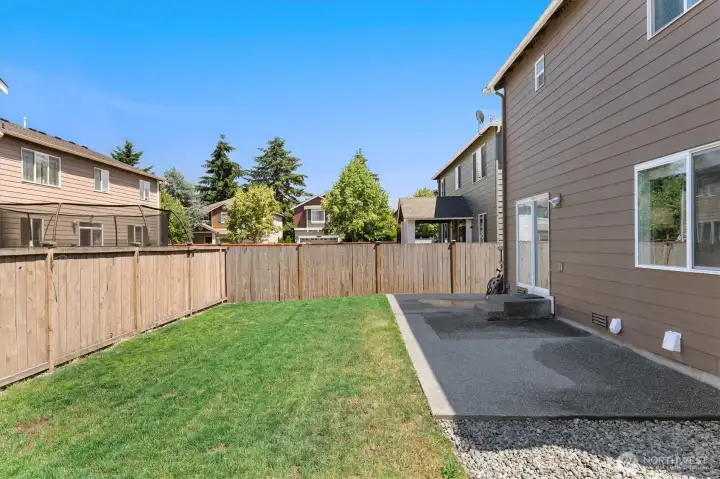 Fully-fenced backyard with extended patio
