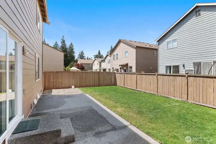 Fully-fenced backyard with extended patio